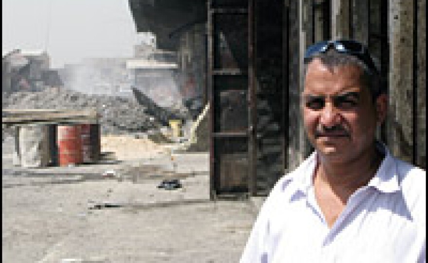 Ehsan Mezher Lafta, 42, says the security barrier makes it costly and difficult to bring in construction materials so he can rebuild his wholesale produce business. Even if he does rebuild, he worries that customers will find it too difficult to get into the market to buy his goods.