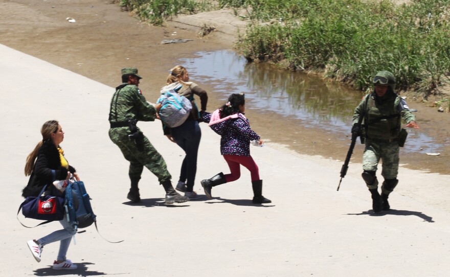Mexican National Guard members prevent Central American migrants from trying to cross the Rio Grande from Juárez, Mexico, on June 21.