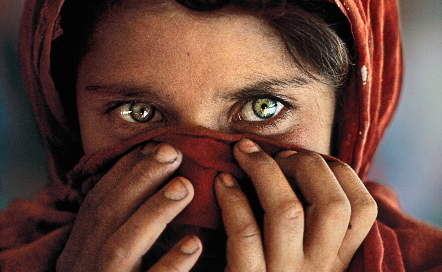 When McCurry started taking Gula's photo, she put her hands up to cover her face. But her teacher asked her to put her hands down so the world would see her face and know her story.