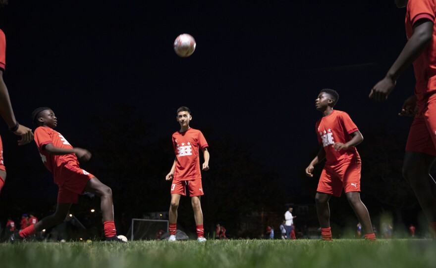 Fifteen-year-olds from a DCXI soccer team practice together in Washington, D.C., in November. Club co-founder and coach Pierre Hedji says some of their team members pay and some don't. "If you can afford to pay the whole thing, pay the whole thing. That way we can afford to help the next kid that can't pay anything at all."