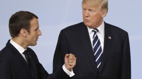 France's President Emmanuel Macron talks with U.S. President Donald Trump after the family photo on the first day of the G-20 summit in Hamburg, northern Germany, Friday, July 7, 2017. 