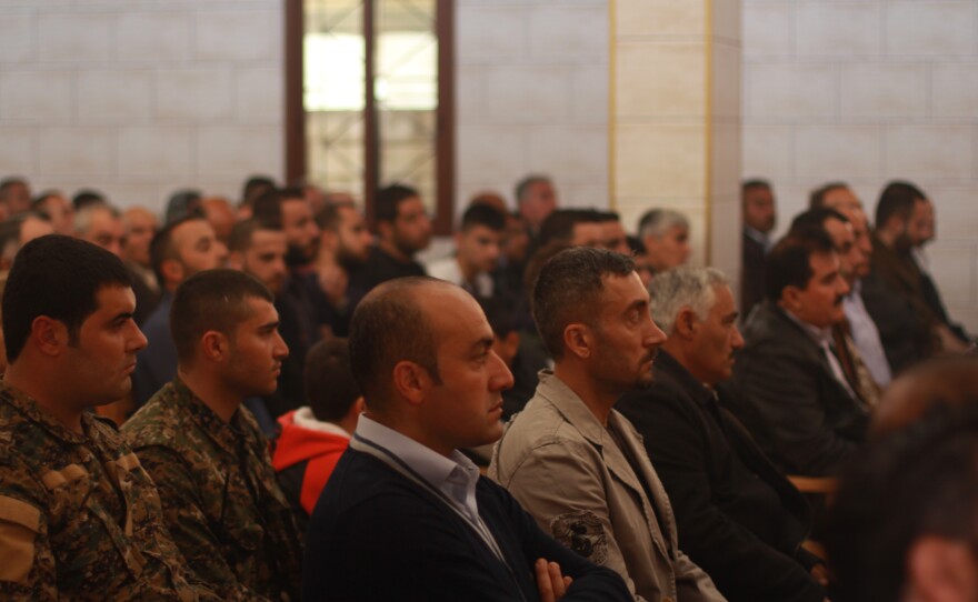 Front rows of the Church of Our Lady in Tell Tamer, Syria, are filled with Assyrian Christians. In uniform, left, is Kino Gabriel, spokesman of an armed Assyrian militia formed to protect from ISIS.
