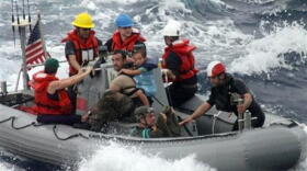 In this photo provided by the U.S. Coast Guard, sailors from Oliver Hazard Perry-class frigate USS Vandegrift (FFG 49) assist in the rescue of a family with a sick infant via the ship's small boat as part of a joint U.S. Navy, Coast Guard and California Air National Guard rescue effort, Sunday, April 6, 2014. 

