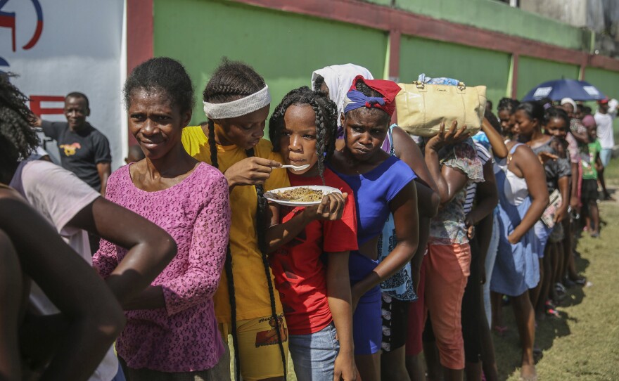<strong data-stringify-type="bold">Mon., Aug. 16: </strong>Residents line up during food distribution at a camp for residents displaced by the earthquake.