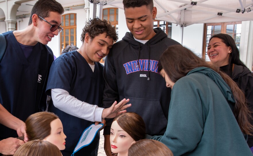 Mannequin heads offer a chance for men to practice hairstyling. Luis Rodríguez (second from left), a medical student, says the lesson made him appreciate his mom's workload at home. As for ponytails, he said he'd tried to do his sister's hair before, but this was the first time he felt confident about the result. "It looked really, really good, the way my mom does it," he says.