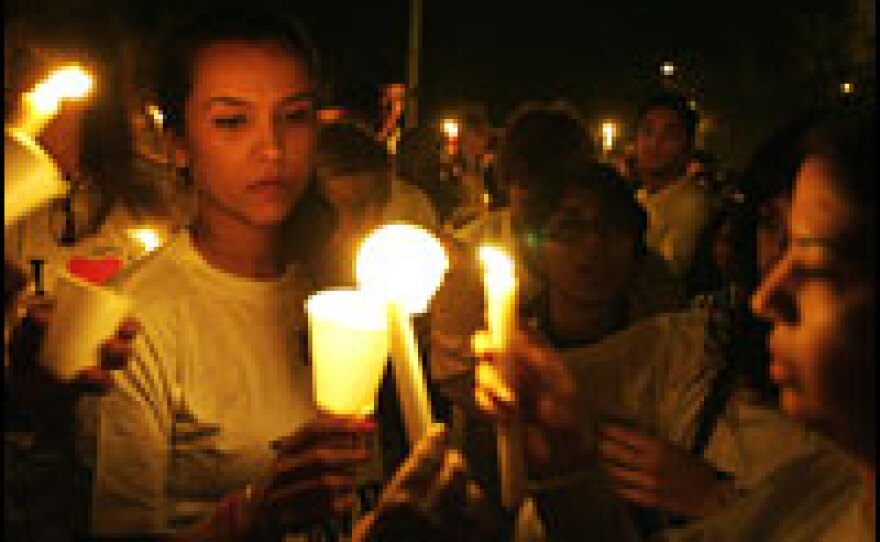 People take part in a candlelight vigil in memory of those who died in last week's terrorist attacks, in New Delhi on Wednesday.