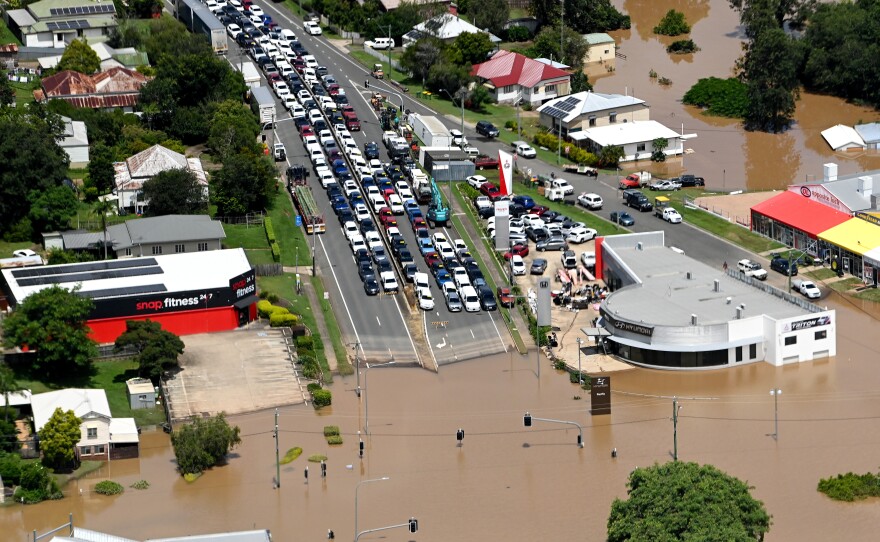 In an aerial view, vehicles are seen stuck along a street as floodwaters surround Gympie, Australia, on Sunday in an area north of Sunshine Coast.