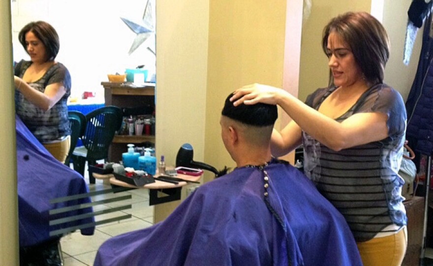 Health workers know places like Karina Cardoso's beauty salon in St. Paul, Minn., are prime places share information about the state's new health insurance options.