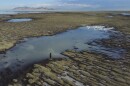 Angelic Lemmon, a park ranger for Utah's Department of Natural Resources, walks across reef-like structures called microbialites, exposed by receding waters at the Great Salt Lake, on Sept. 28, 2022, near Salt Lake City.