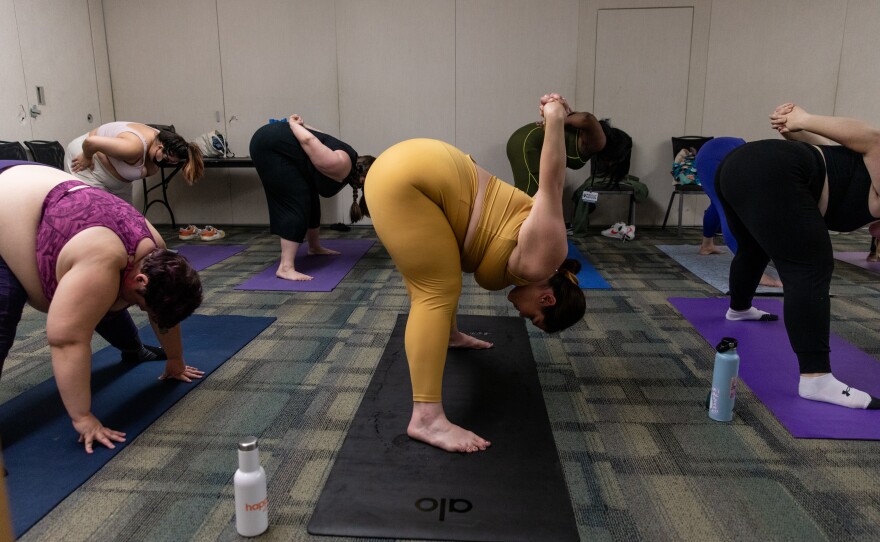 Attendees participate in the breathe and flow yoga class at Philly FatCon last month. During the session, instructor Laura Zales spoke about taking up space and proper weight distribution. Attendees ranged in age, size and gender.