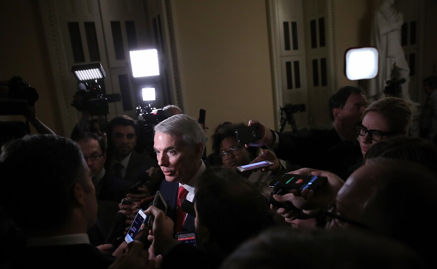 Senate Finance Committee member Sen. Rob Portman, R-Ohio, discusses progress on the GOP tax bill with reporters at the Capitol on Friday.