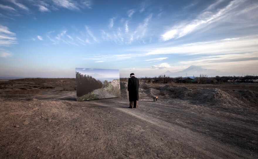 "My home," exclaims Movses Haneshyan, on seeing the enlarged image presented to him by photographer Diana Markosian. He'd fled with his father at age 5.