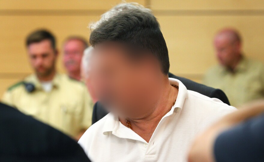Truck driver Michael Harry K. is brought into a courtroom in the regional court in Wuerzburg, Germany, on Monday. His face is blurred in accordance with German laws.