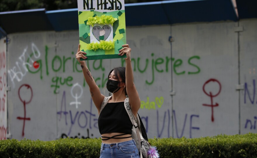 A woman holds a placard that reads in Spanish "Neither Dead Nor or in Prison," during an abortion-rights demonstration on the Day for Decriminalization of Abortion in Latin America, in Mexico City, on Sept. 28, 2021.