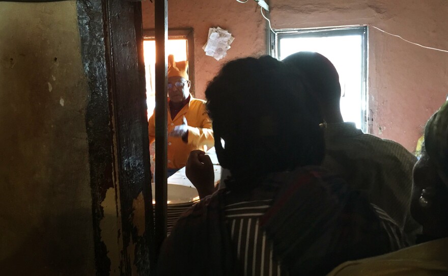 Customers queue up, waiting to order from Chef Chane in Addis Ababa, Ethiopia. He runs his restaurant like a fiefdom, dispensing food and insults majestically from the kitchen, which doubles as a serving station.