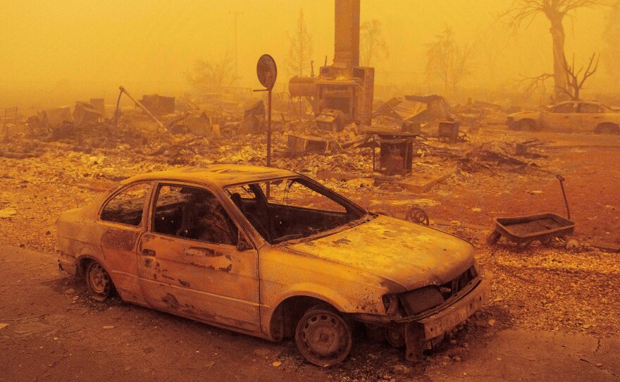 A burned residence rests in heavy smoke on Friday after being burned by the Dixie fire in Greenville, Calif. The fire is now the second-largest in recorded state history.