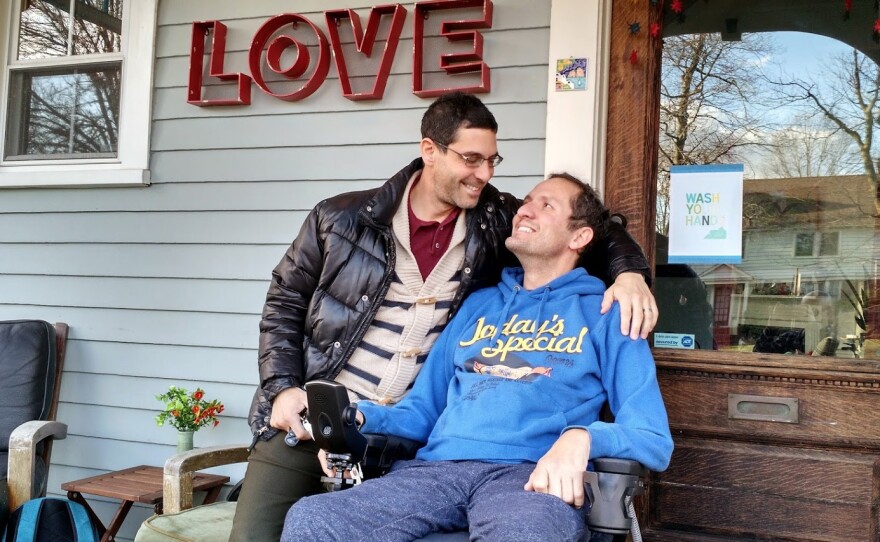 Dave Adox, right, and his husband Danni Michaeli at their home in South Orange, N.J., in the fall of 2014. Adox was diagnosed with ALS at age 42 and became almost totally paralyzed within six months. He died last May.