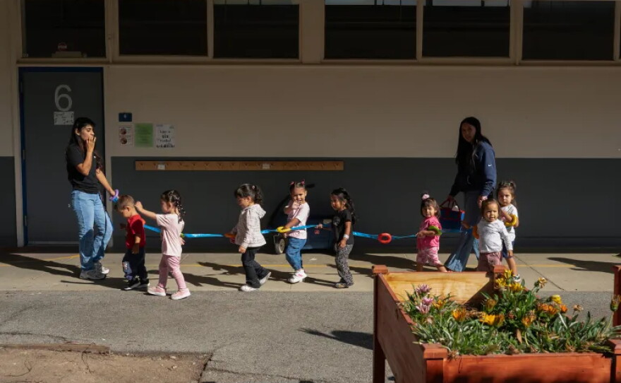Childcare workers lead toddlers to an outdoor playground at Kidango Toyon Early Learning Center in San Jose on Sept. 15, 2026.