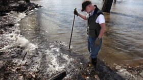 Mac Butler stands in his flooded backyard as the Red River continues to rise in Fargo, N.D. The river is expected to crest at 38 feet on Sunday.