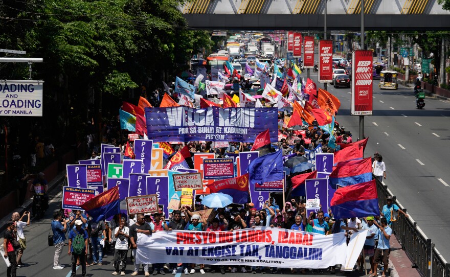 Protesters march during a rally by transport workers and activists protesting the rise in oil prices on Friday, March 27, 2026, near the Malacanang presidential palace in Manila, Philippines.