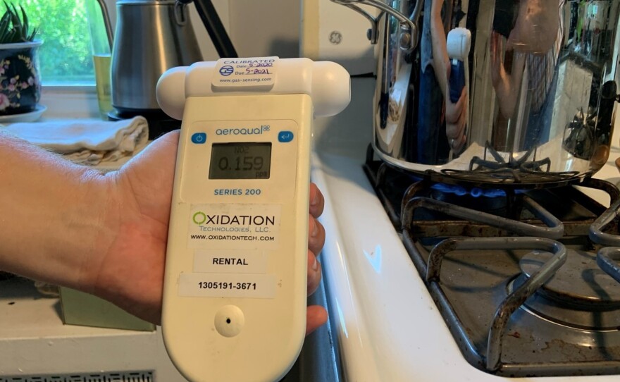 A nitrogen dioxide air monitor in Josiah Kephart's kitchen shows 0.159 parts per million, or 159 parts per billion. That's above the World Health Organization hourly guideline of 106 ppb.