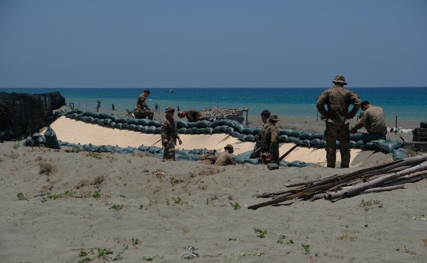 Soldiers of the U.S. Army's 25th Infantry Division build fighting positions along the beach of the La Paz sand dunes in Laoag City, Philippines, ahead of counterlanding exercises during annual Balikatan drills.