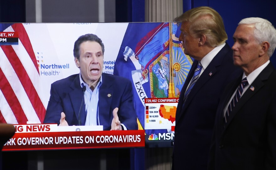 Some 78% of New York voters say they trust Gov. Andrew Cuomo to decide when to reopen their state, compared to 16% who say they trust President Trump. Here, Trump and Vice President Mike Pence watch a video of Cuomo speaking, during a coronavirus task force briefing at the White House last week.