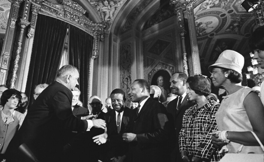 President Lyndon B. Johnson, Martin Luther King Jr., and Rosa Parks at the signing of the Voting Rights Act on Aug. 6, 1965.