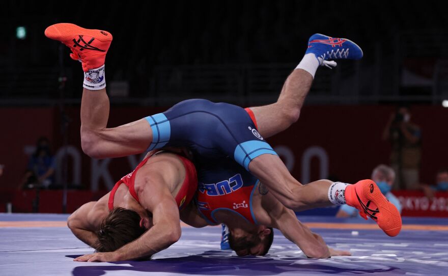 Cuba's Mijain Lopez Nunez (blue) wrestles Moldova's Victor Ciobanu in their men's greco-roman 60kg wrestling semi-final match on August 1.