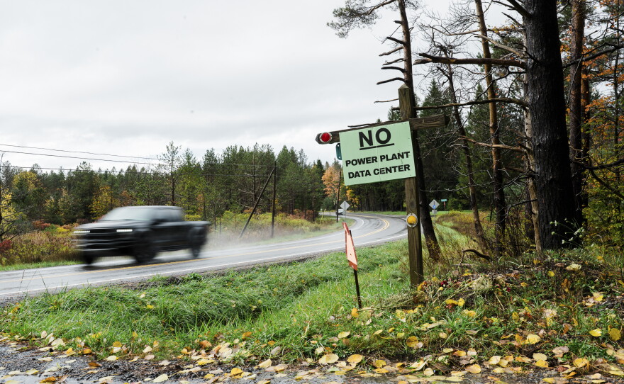 A motorist drives past a "No Power Plant Data Center" sign in Canaan Valley, W.Va. (Chris Jackson/For NPR)