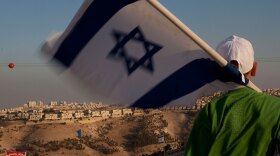 A boy waves a flag during a protest of Maale Adumim, West Bank, a Jewish settlement east of Jerusalem.