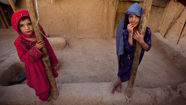 FILE: Zareena, left, and Shakeela, internally displaced Afghan girls play outside a shanty at a refugee camp in the outskirts of Kabul, Afghanistan, Monday, July 25, 2011.