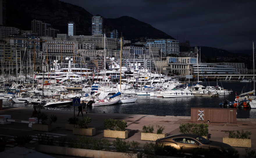 FILE - A luxury car drives along Monaco Harbor, Nov. 19, 2020.