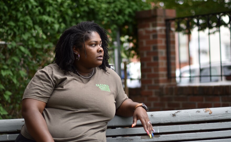 Shakira Franklin sits in a lot near her home, where she often takes breaks from her nearby job. Franklin is working to build a splash park in the lot for neighborhood residents to cool off in the summer heat.