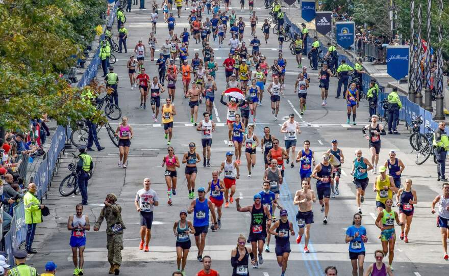 Runners make their way to the finish line down Boylston Street during the 125th Boston Marathon in Boston, Massachusetts on Monday. It's the first time the event has been held in the fall in more than a century.