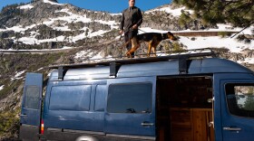 Travis Wild eats breakfast with his dog, June 19, 2019. 