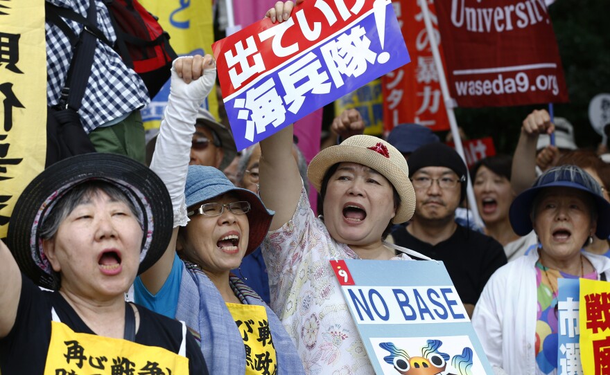 Anti-U.S. base protesters shouts slogans at Sunday's rally.