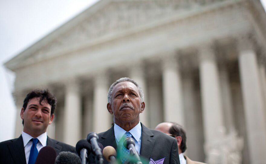 Otis McDonald (C), lead plaintiff, and his legal team speak to reporters after a ruling in their case seeking to overturn Chicago's ban on handguns.