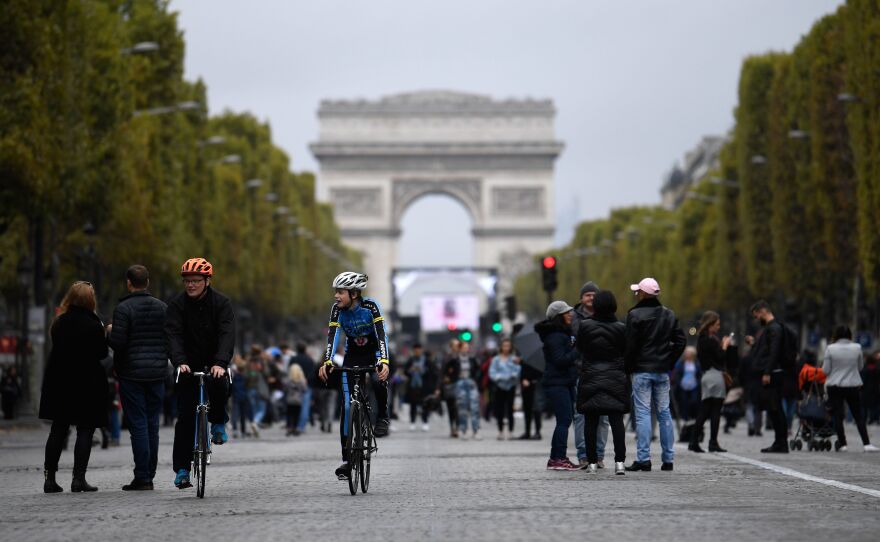 Mayor Anne Hidalgo has called for an end to gas-powered vehicles in Paris by 2030, in favor of biking, transit, and electric cars. Here, cyclists and pedestrians on the Champs- Élysées during the city's "day without cars" on Oct. 1.