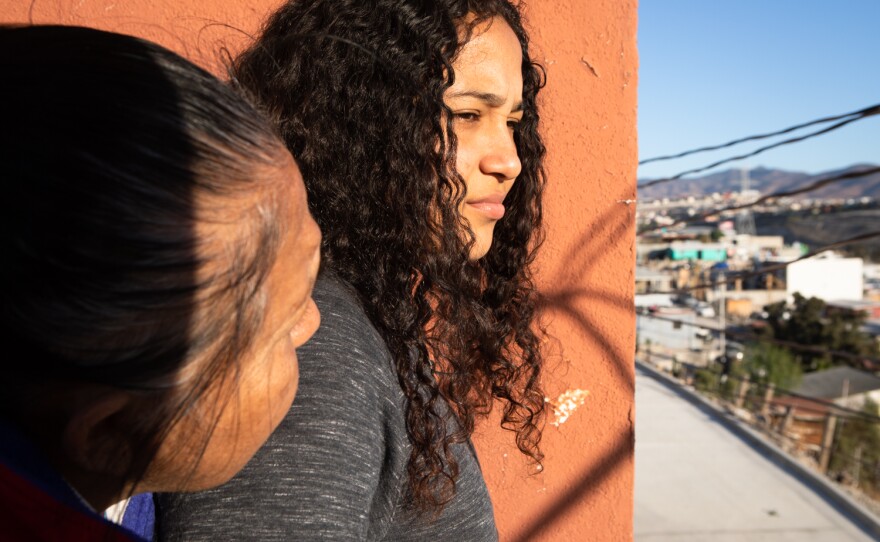 Laura Melissa Serrano Aguilar and her mother María Dolores Aguilar look at the view from a balcony at the Libélula Women's Shelter in Tijuana, Dec. 16, 2022.