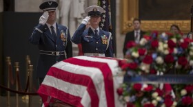 A final salute is rendered by the honor guard standing watch over the flag-draped casket of the late president, George H.W. Bush, as the public viewing comes to an end at the U.S. Capitol Rotunda, Wednesday, Dec. 5, 2018.