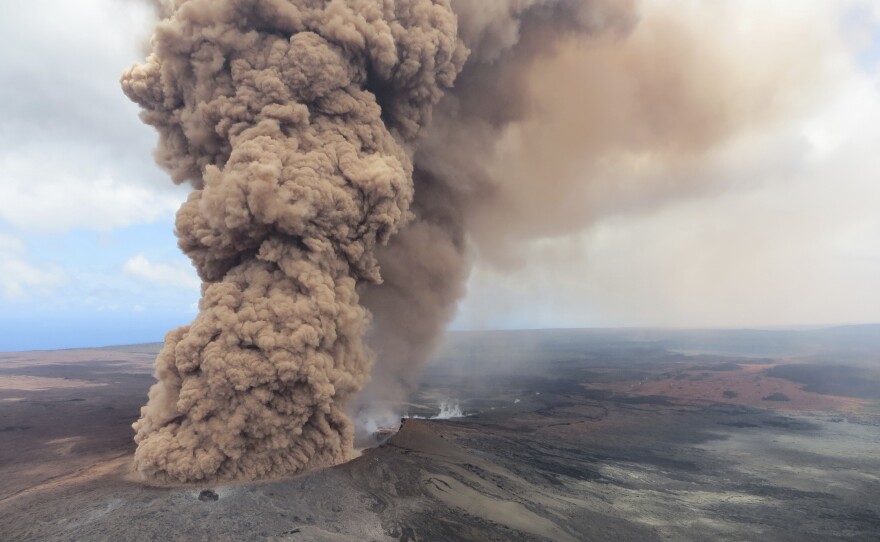 A column of thick, reddish-brown ash rises in the air on Friday, after a magnitude 6.9 earthquake shook Hawaii's Big Island.