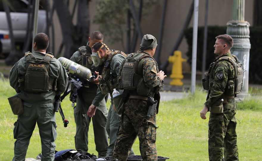 Honolulu police gather near the scene of a shooting near Diamond Head State Monument on Sunday.