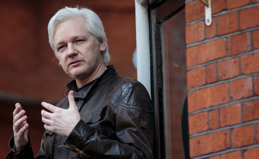 Julian Assange speaks to the media from the balcony of the Ecuadorian Embassy in London last year.