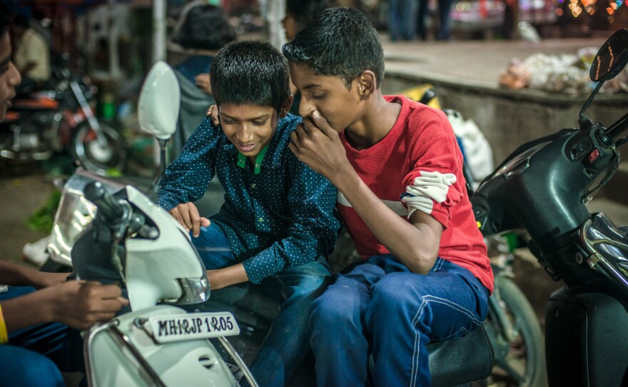 Working at the market gives Aniket a chance to catch up with his friends.