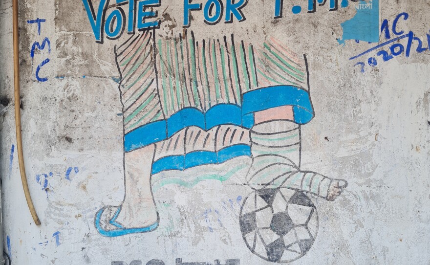 Graffiti in central Kolkata depicts Mamata Banerjee playing soccer with a cast on her leg. "Vote for TMC" is a reference to Banerjee's political party, the All India Trinamool Congress, or TMC. In May, Banerjee campaigned in state elections with a cast on her leg, after she was injured in a melee that some members of her party blamed on operatives from a rival party.