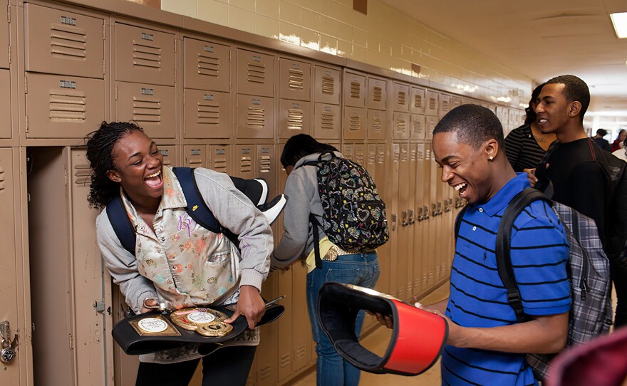 Claressa, showing her championship belts to a classmate, was a high school junior when she won the Olympic gold in 2012. She is the first in her family to graduate from high school. She won a scholarship to Olivet College and studied for a semester, but was unable to keep up with classes and her international tournament schedule. She plans to study again after Rio.
