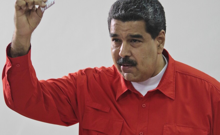 Venezuela's President Nicolás Maduro shows his ballot after casting a vote in 2017 for a constitutional assembly in Caracas, Venezuela.