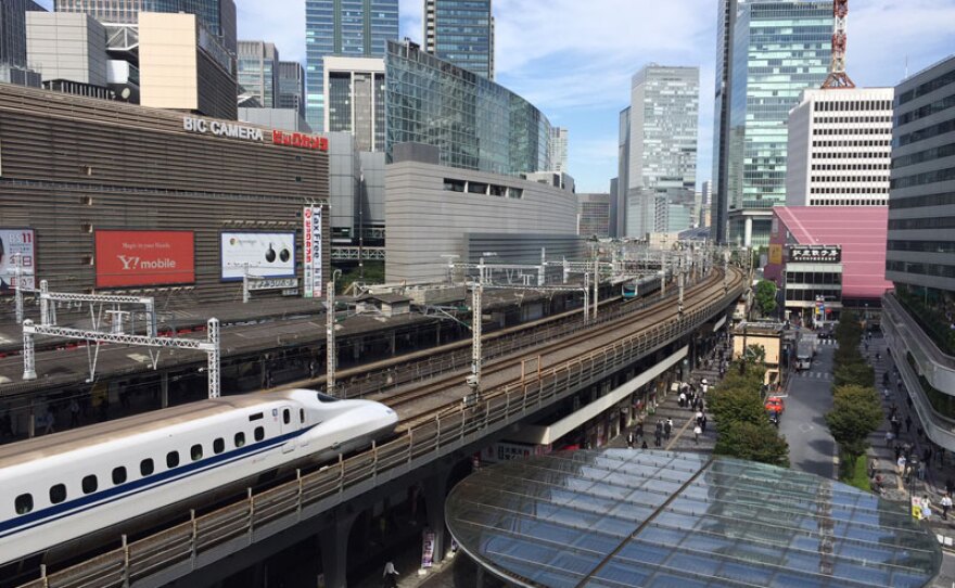 Japan high speed train and cityscape.