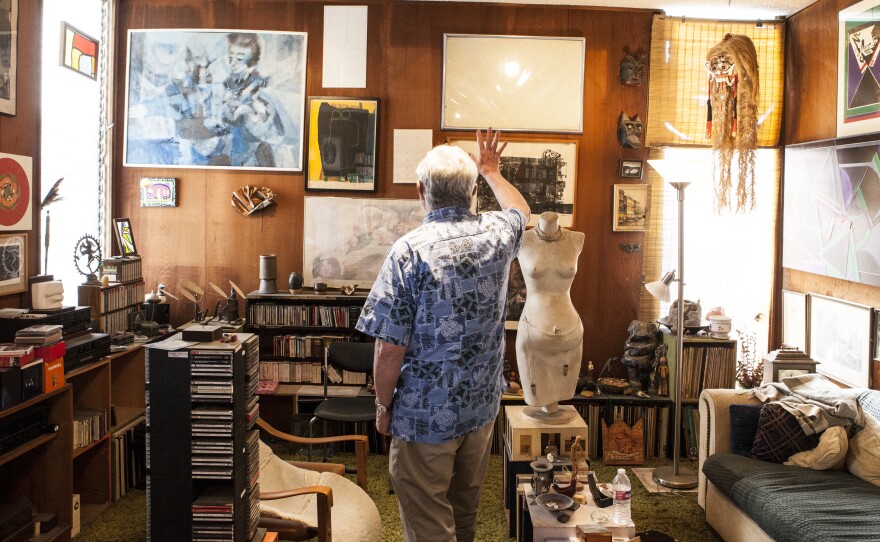 Walter Pomeroy points out the holes in his art collection since pieces were moved to the downtown library for a new exhibition on March 9, 2016.